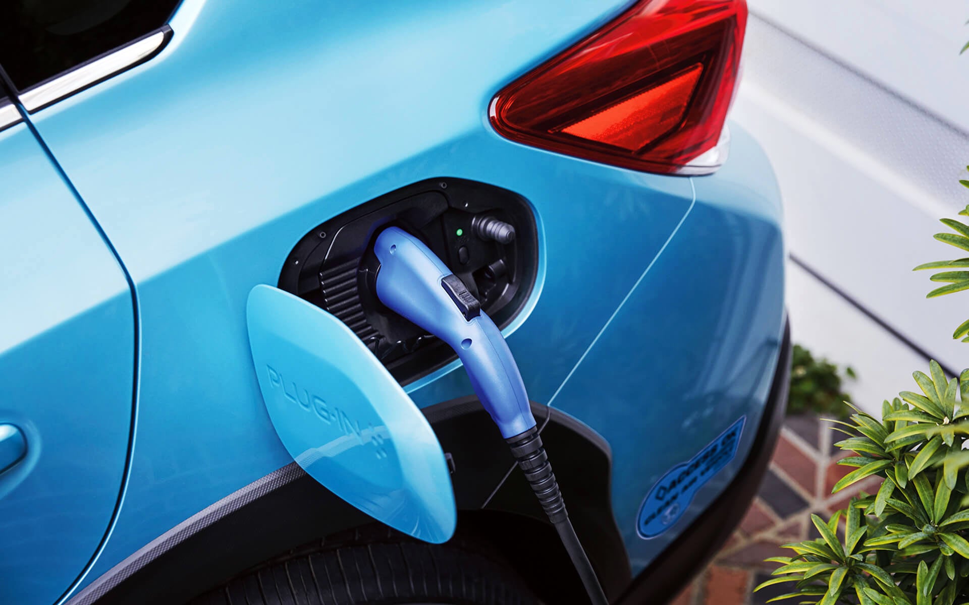 A close-up of the Subaru Crosstrek Hybrid's charging port with charging cable plugged in | Dutch Miller Subaru in Charleston WV